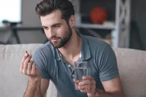 Men takes tablet